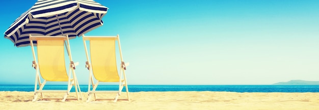 Wooden deck chairs on sandy beach near sea. Holiday background.