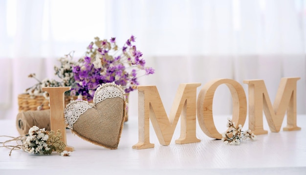 Wooden decoration with flowers in front of the window