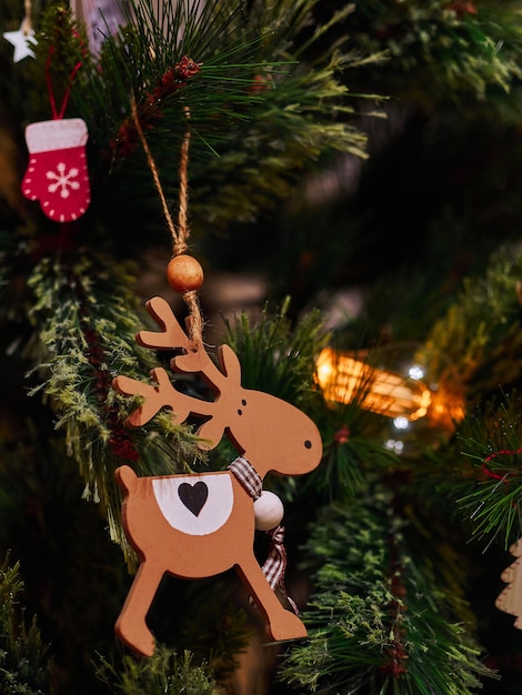 Wooden deer Christmas toys and flashlights on the Christmas tree