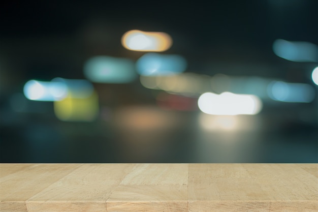 Wooden desk with blue bokeh. blurred light on blue background