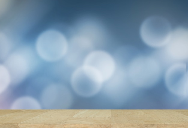 Wooden desk with Blurred Lights on blue background or Lights on blue background.