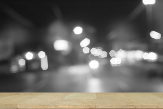 Wooden desk with Grey gradient blurred abstract background.