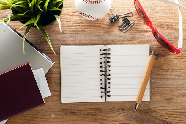 Wooden desktop with blank notebook paper background