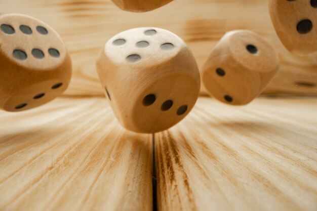 Wooden dice tossed on wooden background close up photo