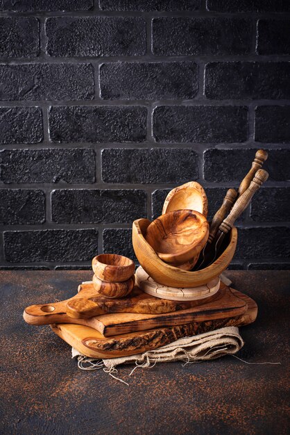 Wooden dishes on a brick wall background