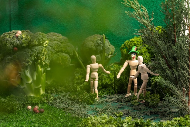 Wooden dolls playing in a miniature forest