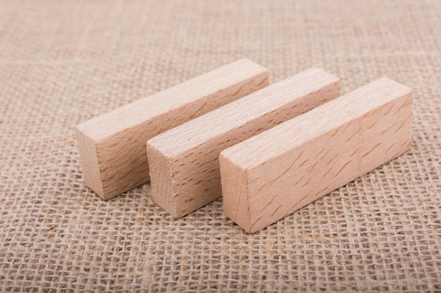 Wooden domino on linen canvas