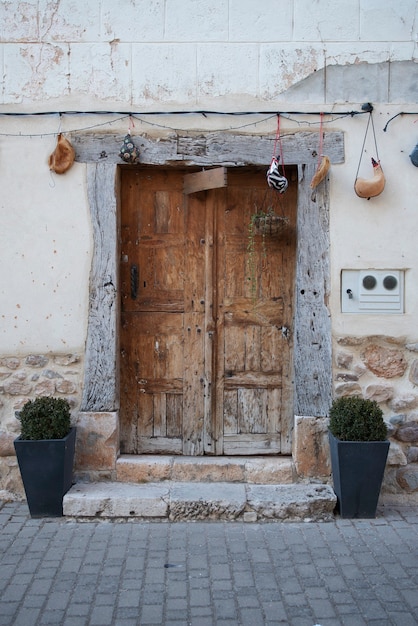 Wooden door to access the house, old and made of elaborated wood.