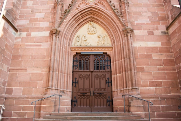 Wooden door for German people and foreigner travelers entrance in St Gallus church for visit and praying at Ladenburg town on August 28 2017 in Badenwurttemberg Germany