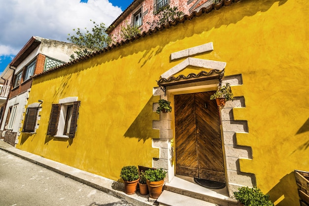 Wooden door in a rustic wall in Sardinia