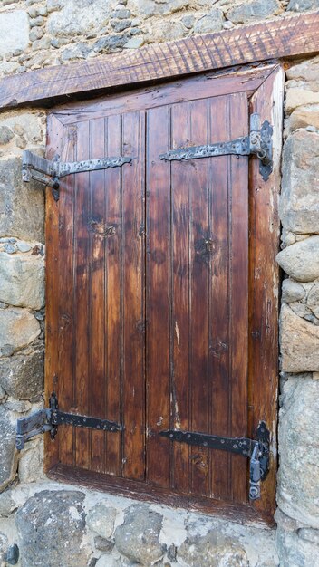 Wooden door in a stone wall in the village of Kakopetria, Cyprus.