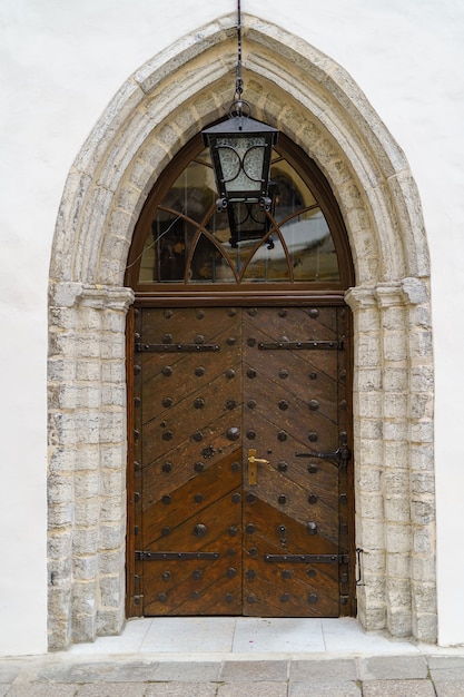 Wooden door in very old building of the medieval city.