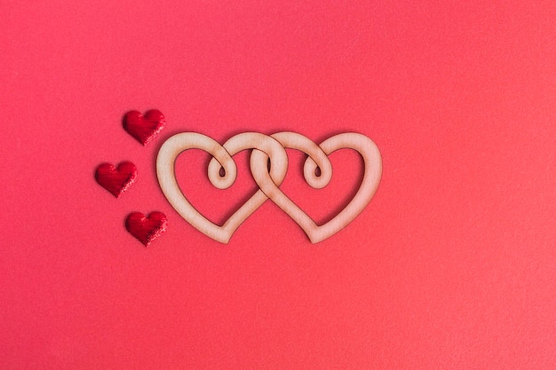 Wooden double heart on a red background with copy space. Love concept, valentine's day