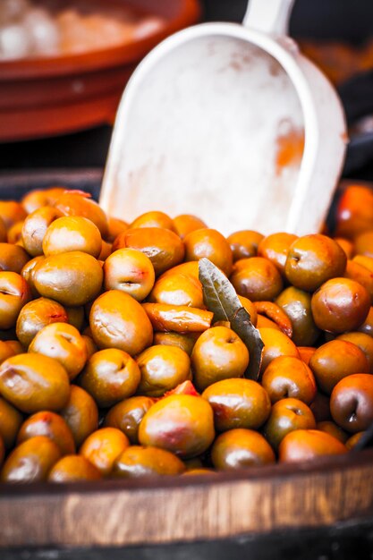 Wooden drums with olives and variants