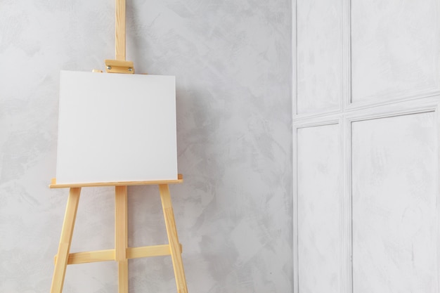 Wooden easel in the room