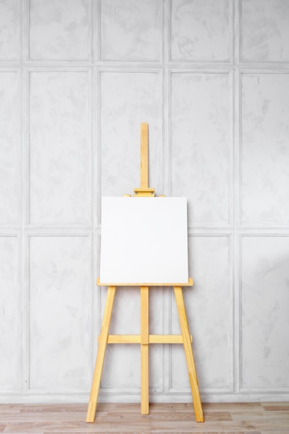 Wooden easel in the room