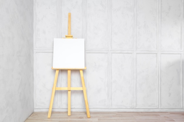 Wooden easel in the room