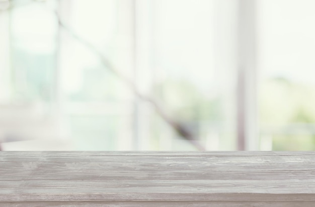 Wooden empty board in front of blurred curtained window background