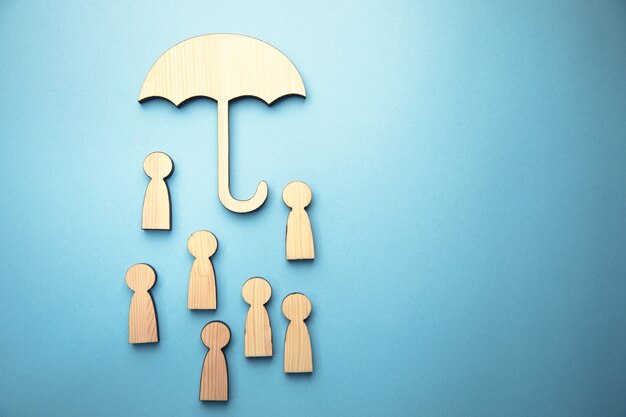 wooden family and umbrella sign on blue surface