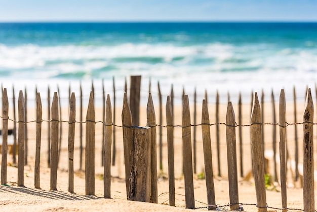 Wooden fence on an Atlantic beach in France The Gironde Department Shot with a selective focus