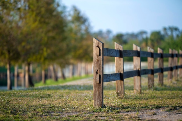 Wooden fence barrier at farm grounds for cattle and territory protection