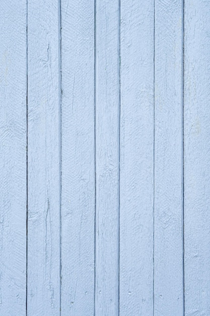 wooden fence closeup of thin boards painted with grayblue paint