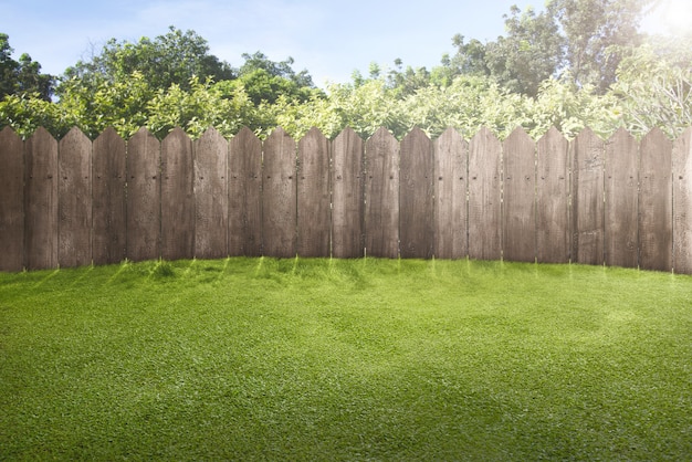 Wooden fence on green garden