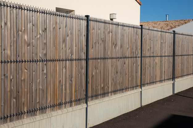 Wooden fence house facade in front of home wood garden protect