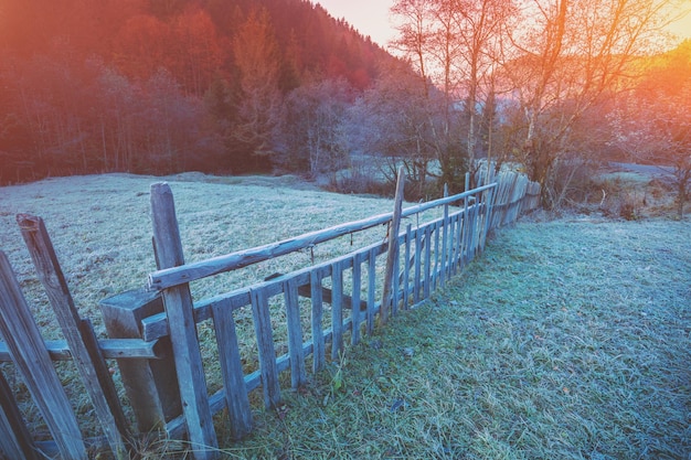 Wooden fence on the mountainside. Frosty morning in the mountains