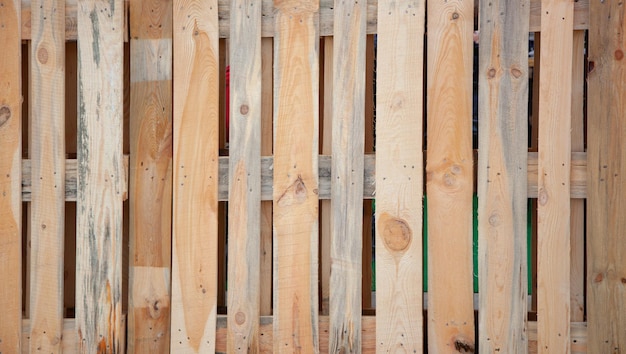 Photo wooden fence vertical boards knocked down by nails