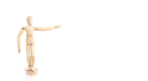 wooden figure of a man shows with his hand the direction on a white background, mock up a place to insert text or objects.