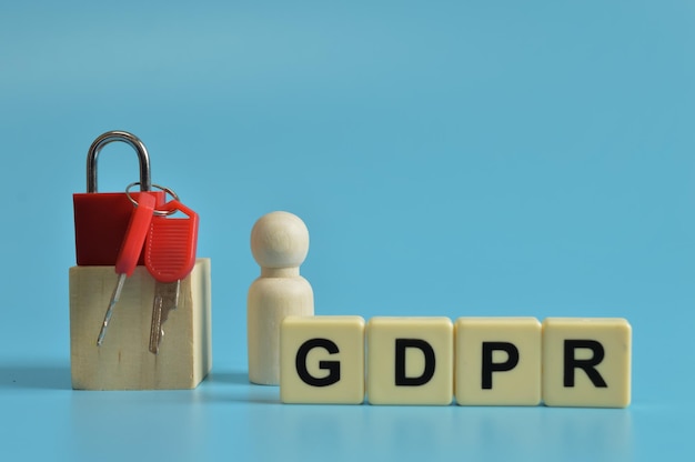 Wooden figure padlock keys and alphabet letters with text GDPR stands for General Data Protection Regulation