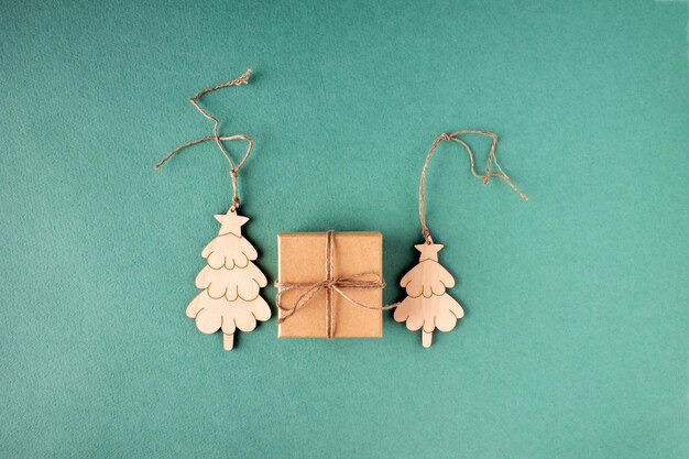 Wooden figures of Christmas trees and a gift in a craft box