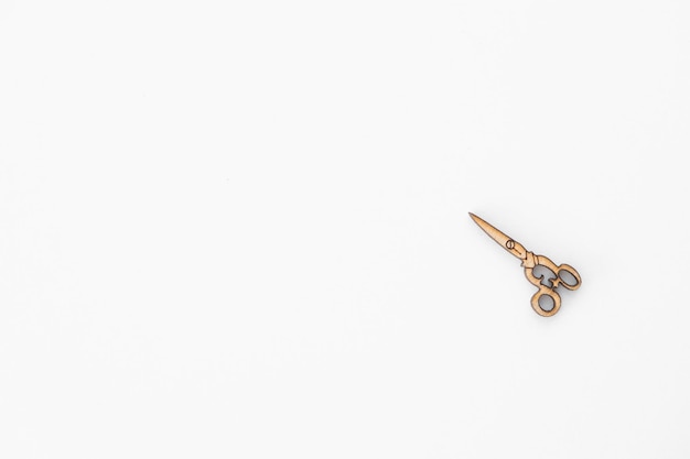 Wooden figures in the form of scissors on a white background