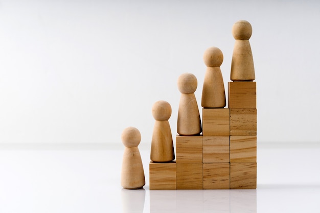 Wooden figures stand on the cubes that represent the stairs