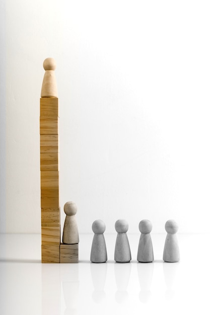 Wooden figures stand on the cubes that represent the stairs.