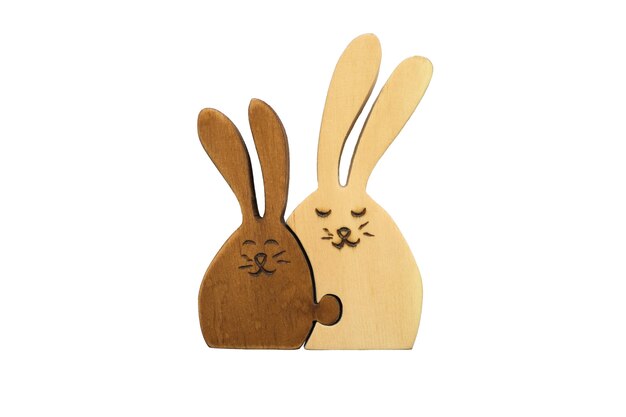 Wooden figures of two hares together isolated on white Concept of family love mother and child