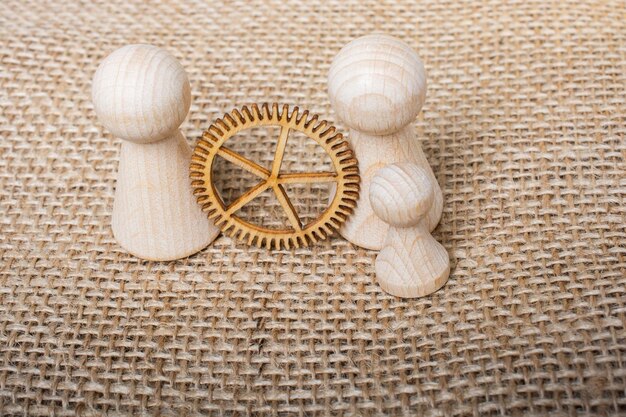 Wooden figurines of people and and gear wheel