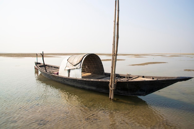 Wooden Fishing boat in the river water under the blue sky Beautiful Landscape Scenery