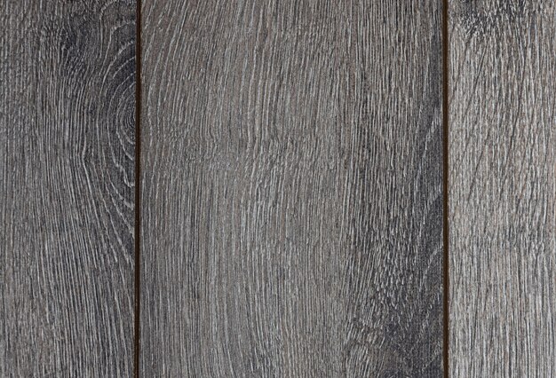 Foto pavimento di legno. laminato grigio o parquet. tavola rettangolare sul pavimento. struttura di legno