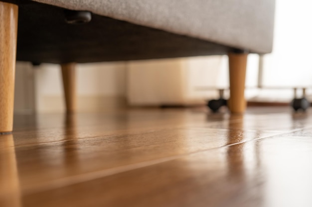 Wooden floor, a sofa, and windows in the living room.