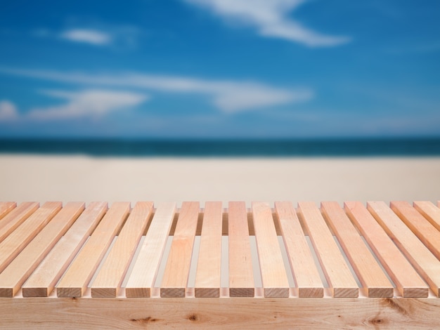 Wooden floor with beach, blue sea and blue sky background