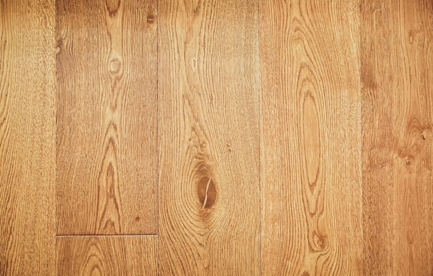 A wooden floor with a pattern of light brown wood.