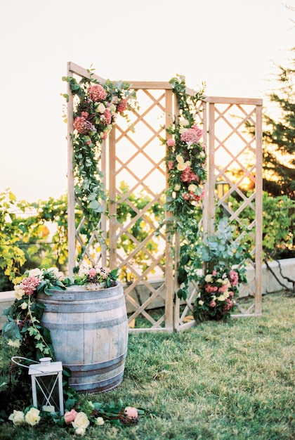 Wooden folding wedding screen decorated with flowers in the garden