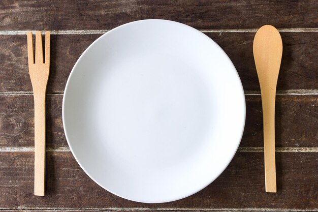 Wooden fork and spoon and empty plate