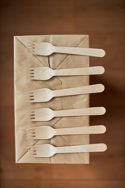 Wooden forks on a background of crumpled paper Eco wooden plugs