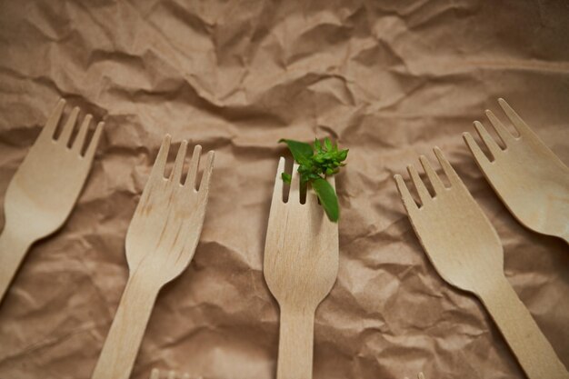 Wooden forks on a background of crumpled paper Eco wooden plugs