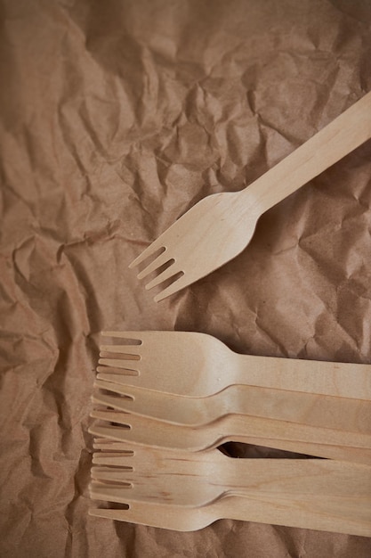 Wooden forks on a background of crumpled paper Eco wooden plugs