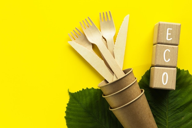 Photo wooden forks and knives in craft paper cup