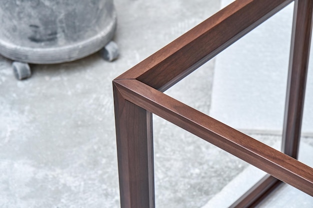 Wooden frame of bedside table made of solid walnut in workshop closeup